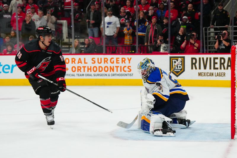 Jan 6, 2024; Raleigh, North Carolina, USA; St. Louis Blues goaltender Jordan Binnington (50) stops the shoot out attempt by Carolina Hurricanes left wing Teuvo Teravainen (86) at PNC Arena. Mandatory Credit: James Guillory-USA TODAY Sports