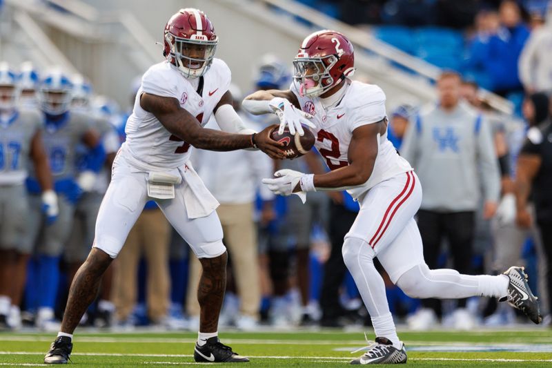 Nov 11, 2023; Lexington, Kentucky, USA; Alabama Crimson Tide quarterback Jalen Milroe (4) hands the ball off to running back Jase McClellan (2) against the Kentucky Wildcats during the third quarter at Kroger Field. Mandatory Credit: Jordan Prather-USA TODAY Sports