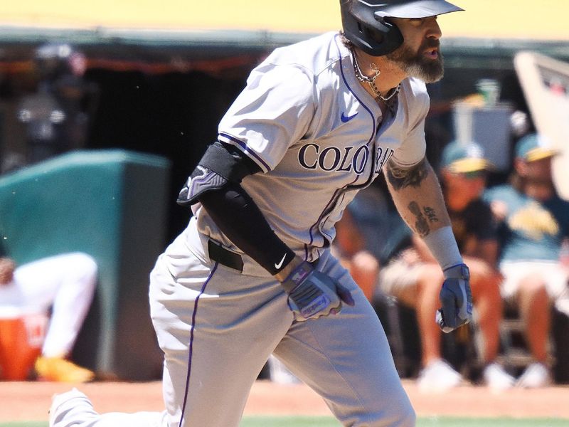 May 23, 2024; Oakland, California, USA; Colorado Rockies right fielder Jake Cave (11) runs for a single against the Oakland Athletics during the sixth inning at Oakland-Alameda County Coliseum. Mandatory Credit: Kelley L Cox-USA TODAY Sports