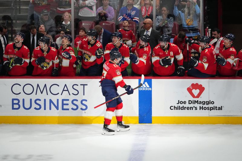 Dec 29, 2023; Sunrise, Florida, USA; Florida Panthers center Evan Rodrigues (17) celebrates his goal against the New York Rangers with teammates on the bench during the first period at Amerant Bank Arena. Mandatory Credit: Jasen Vinlove-USA TODAY Sports