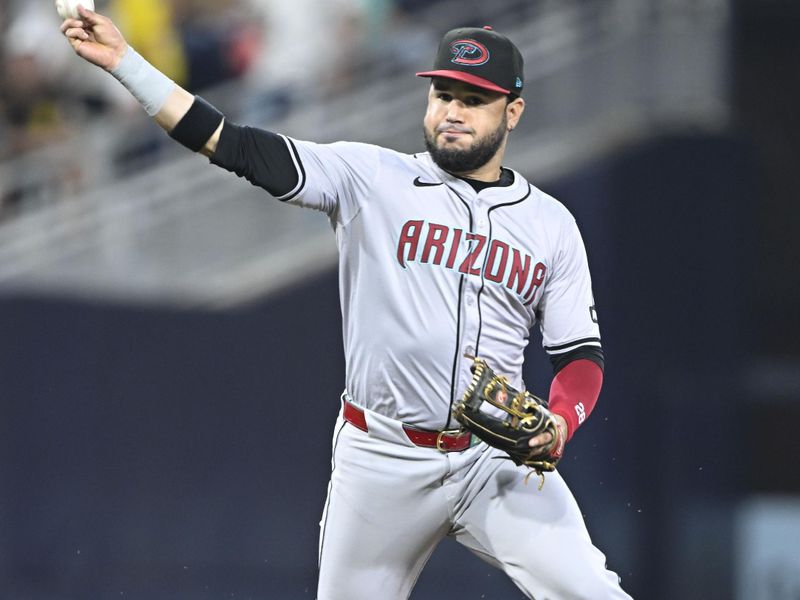 July 5, 2024; San Diego, California, USA; Arizona Diamondbacks third baseman Eugenio Suarez (28) throws to first base but can’t get the out on San Diego Padres third baseman Donovan Solano (39) during the fifth inning at Petco Park. Mandatory Credit: Denis Poroy-USA TODAY Sports at Petco Park. 