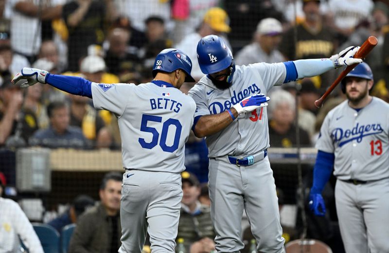 Oct 9, 2024; San Diego, California, USA; Los Angeles Dodgers shortstop Mookie Betts (50) celebrates with outfielder Teoscar Hernandez (37) after hitting a home run in the first inning against the San Diego Padres during game four of the NLDS for the 2024 MLB Playoffs at Petco Park.  Mandatory Credit: Denis Poroy-Imagn Images