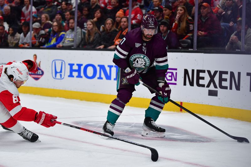 Jan 7, 2024; Anaheim, California, USA; Anaheim Ducks left wing Alex Killorn (17) moves the puck against Detroit Red Wings defenseman Ben Chiarot (8) during the second period at Honda Center. Mandatory Credit: Gary A. Vasquez-USA TODAY Sports