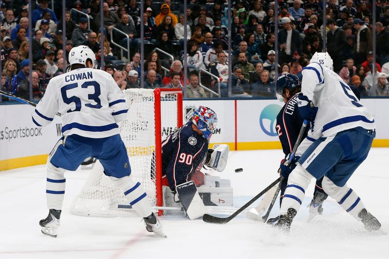 Oct 29, 2025; Columbus, Ohio, USA; Columbus Blue Jackets goalie Elvis Merzlikins (90) makes a save on the shot from Toronto Maple Leafs right wing Easton Cowan (53) during the first period at Nationwide Arena. Mandatory Credit: Russell LaBounty-Imagn Images