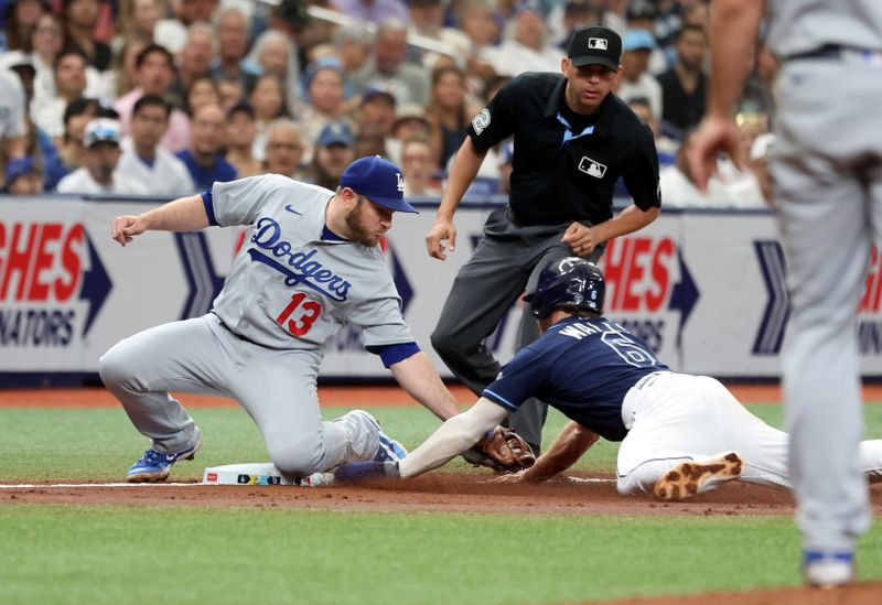 May 27, 2023; St. Petersburg, Florida, USA; Tampa Bay Rays second baseman Taylor Walls (6) slides safely under the tag of Los Angeles Dodgers third baseman Max Muncy (13) during the third inning at Tropicana Field. Mandatory Credit: Kim Klement-USA TODAY Sports