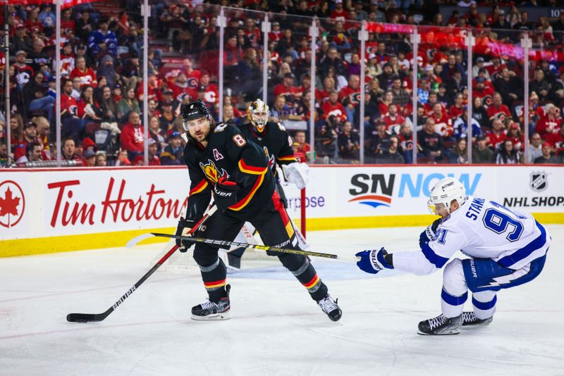 Jan 21, 2023; Calgary, Alberta, CAN; Calgary Flames defenseman Chris Tanev (8) controls the puck against Tampa Bay Lightning center Steven Stamkos (91) during the third period at Scotiabank Saddledome. Mandatory Credit: Sergei Belski-USA TODAY Sports