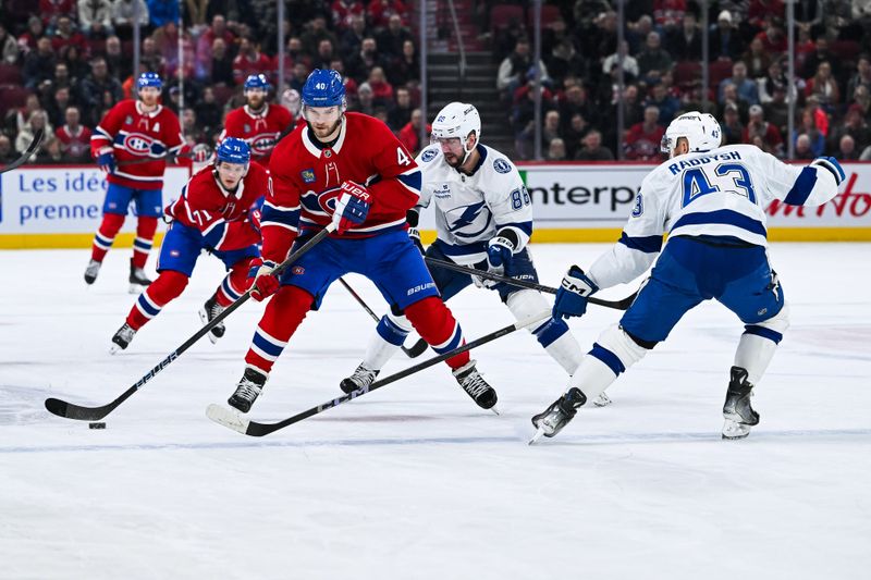 Jan 21, 2025; Montreal, Quebec, CAN; Montreal Canadiens right wing Joel Armia (40) plays the puck against Tampa Bay Lightning right wing Nikita Kucherov (86) during the first period at Bell Centre. Mandatory Credit: David Kirouac-Imagn Images
