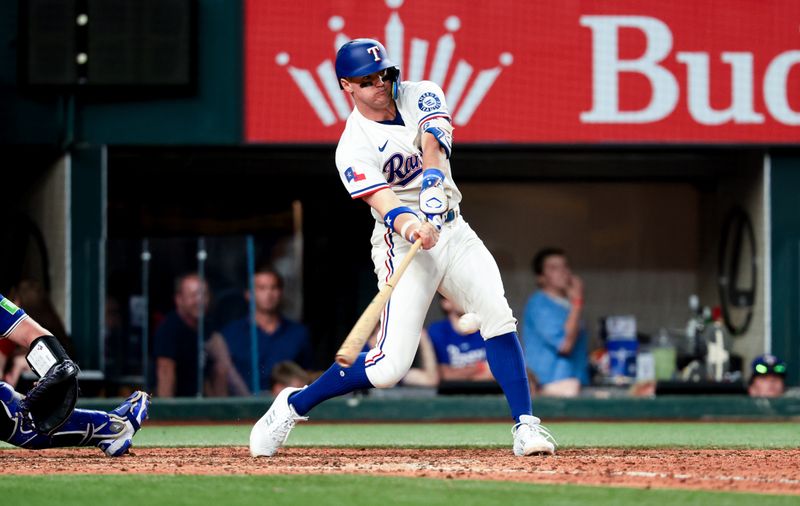 May 27, 2025; Arlington, Texas, USA; Texas Rangers third baseman Josh Jung (6) hits an rbi single during the eighth inning against the Toronto Blue Jays at Globe Life Field. Mandatory Credit: Kevin Jairaj-Imagn Images