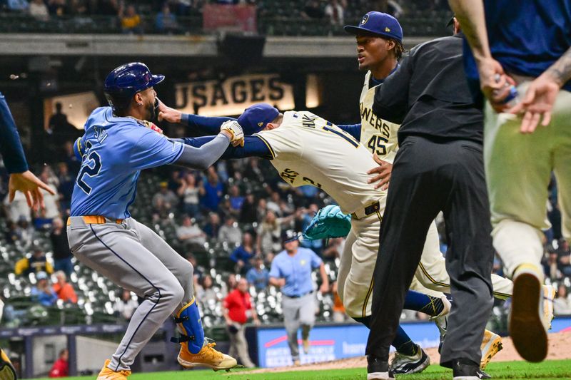 Apr 30, 2024; Milwaukee, Wisconsin, USA;  Milwaukee Brewers first baseman Rhys Hoskins (12) tries to separate Tampa Bay Rays center fielder Jose Siri (22) from pitcher Abner Uribe (45) during a brawl in the eighth inning at American Family Field. Mandatory Credit: Benny Sieu-USA TODAY Sports