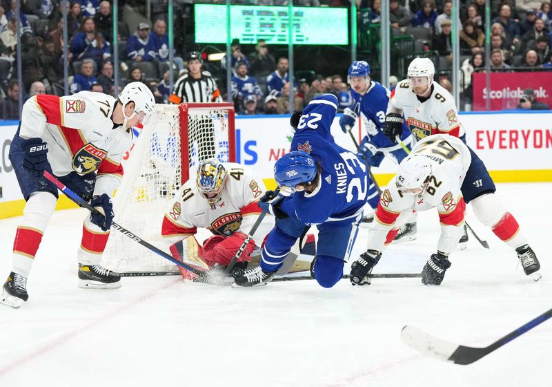 Nov 28, 2023; Toronto, Ontario, CAN; Toronto Maple Leafs left wing Matthew Knies (23) battles for the puck in front of Florida Panthers goaltender Anthony Stolarz (41) during the third period at Scotiabank Arena. Mandatory Credit: Nick Turchiaro-USA TODAY Sports