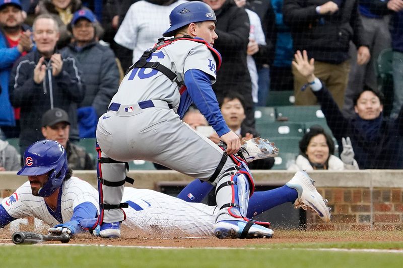 Apr 7, 2024; Chicago, Illinois, USA; Chicago Cubs shortstop Dansby Swanson (7) is safe at home plate as Los Angeles Dodgers catcher Will Smith (16) takes a late throw during the first inning at Wrigley Field. Mandatory Credit: David Banks-USA TODAY Sports