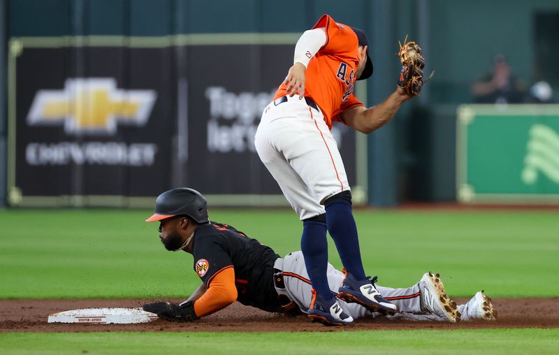 Jun 21, 2024; Houston, Texas, USA; Baltimore Orioles center fielder Cedric Mullins (31) steals second base against Houston Astros second baseman Jose Altuve (27) in the first inning at Minute Maid Park. Mandatory Credit: Thomas Shea-USA TODAY Sports