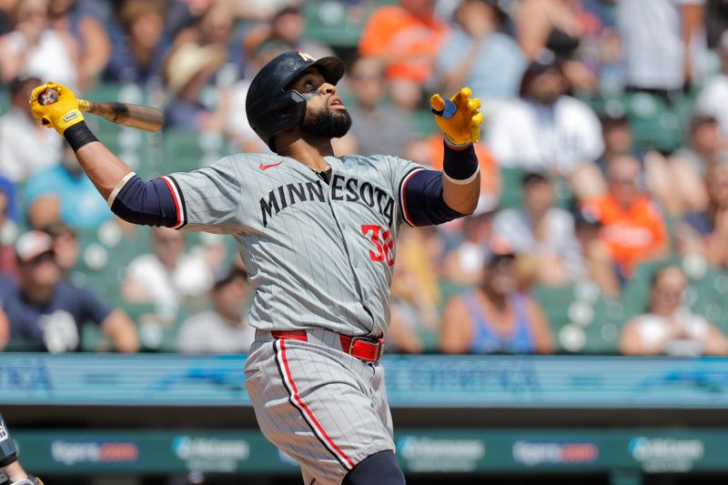 Jul 28, 2024; Detroit, Michigan, USA;  Minnesota Twins first baseman Carlos Santana (30) hits a sacrifice fly to score a run in the third inning against the Detroit Tigers at Comerica Park. Mandatory Credit: Rick Osentoski-USA TODAY Sports