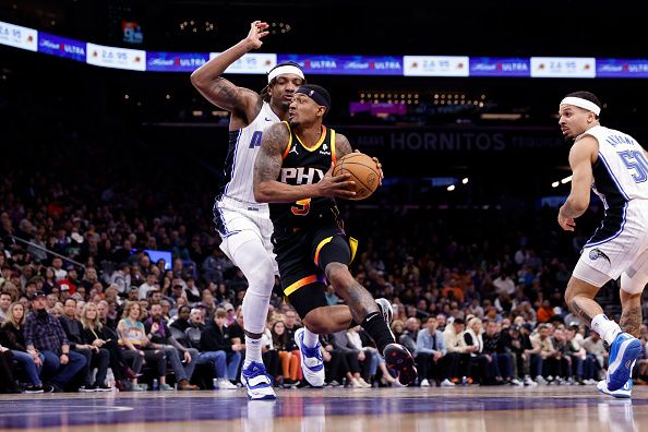 PHOENIX, ARIZONA - DECEMBER 31: Bradley Beal #3 of the Phoenix Suns drives against Wendell Carter Jr. #34 of the Orlando Magic during the second half at Footprint Center on December 31, 2023 in Phoenix, Arizona. NOTE TO USER: User expressly acknowledges and agrees that, by downloading and or using this photograph, User is consenting to the terms and conditions of the Getty Images License Agreement.  (Photo by Chris Coduto/Getty Images)