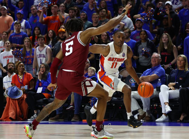 Jan 25, 2023; Gainesville, Florida, USA; Florida Gators guard Kyle Lofton (11) drives to the basket against South Carolina Gamecocks guard Meechie Johnson (5)  during the second half at Exactech Arena at the Stephen C. O'Connell Center. Mandatory Credit: Kim Klement-USA TODAY Sports