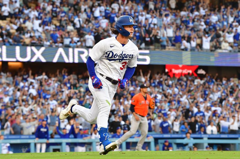 Jun 24, 2023; Los Angeles, California, USA; Los Angeles Dodgers center fielder James Outman (33) hits a ground rule RBI double against the Houston Astros during the eighth inning at Dodger Stadium. Mandatory Credit: Gary A. Vasquez-USA TODAY Sports