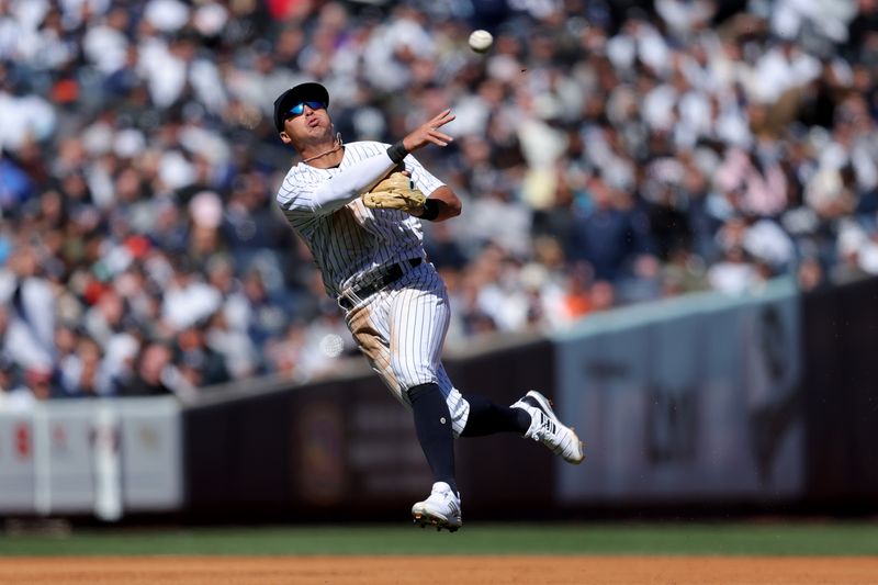 Mar 30, 2023; Bronx, New York, USA; New York Yankees shortstop Anthony Volpe (11) throws out San Francisco Giants second baseman Thairo Estrada (not pictured) during the fourth inning at Yankee Stadium. Mandatory Credit: Brad Penner-USA TODAY Sports