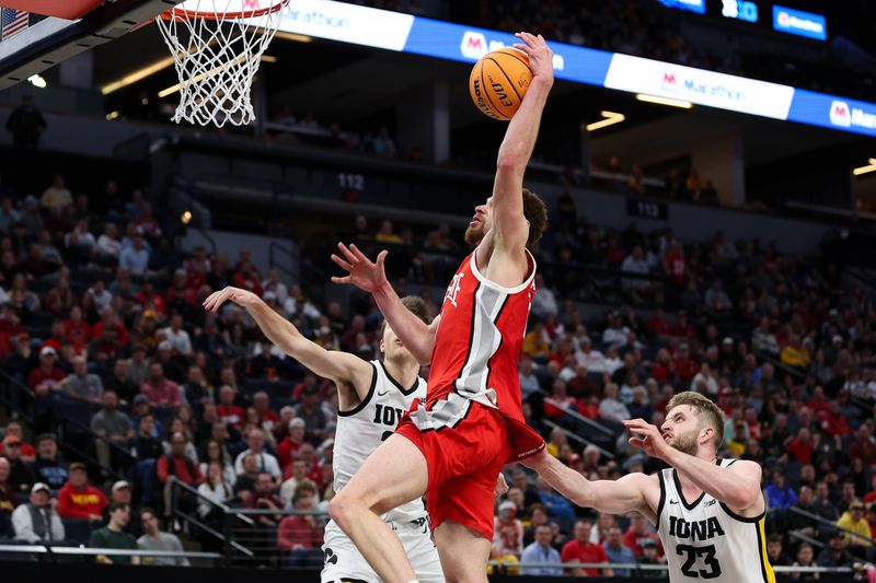 Mar 14, 2024; Minneapolis, MN, USA; Ohio State Buckeyes forward Jamison Battle (10) dunks as Iowa Hawkeyes forward Owen Freeman (32) and Iowa Hawkeyes forward Ben Krikke (23) defend during the second half at Target Center. Mandatory Credit: Matt Krohn-USA TODAY Sports