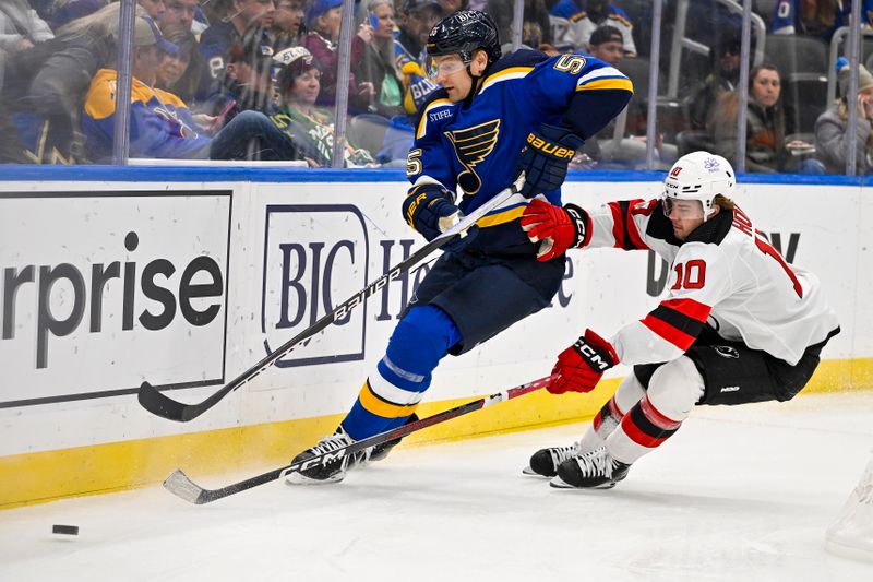 Nov 3, 2023; St. Louis, Missouri, USA;  St. Louis Blues defenseman Colton Parayko (55) and New Jersey Devils right wing Alexander Holtz (10) battle for the puck during the first period at Enterprise Center. Mandatory Credit: Jeff Curry-USA TODAY Sports