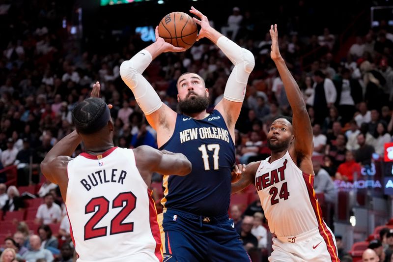 MIAMI, FLORIDA - MARCH 22: Jonas Valanciunas #17 of the New Orleans Pelicans drives to the basket against Jimmy Butler #22 of the Miami Heat during the fourth quarter at Kaseya Center on March 22, 2024 in Miami, Florida. NOTE TO USER: User expressly acknowledges and agrees that, by downloading and or using this photograph, User is consenting to the terms and conditions of the Getty Images License Agreement. (Photo by Rich Storry/Getty Images)