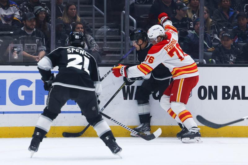 Dec 23, 2023; Los Angeles, California, USA; Calgary Flames center Martin Pospisil (76) checks an Los Angeles Kings player into the boards during the first period at Crypto.com Arena. Mandatory Credit: Jessica Alcheh-USA TODAY Sports