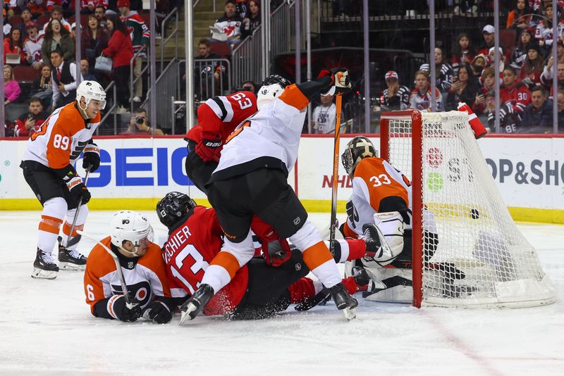 Dec 19, 2023; Newark, New Jersey, USA; New Jersey Devils left wing Jesper Bratt (63) scores a goal on Philadelphia Flyers goaltender Samuel Ersson (33) during the second period at Prudential Center. Mandatory Credit: Ed Mulholland-USA TODAY Sports