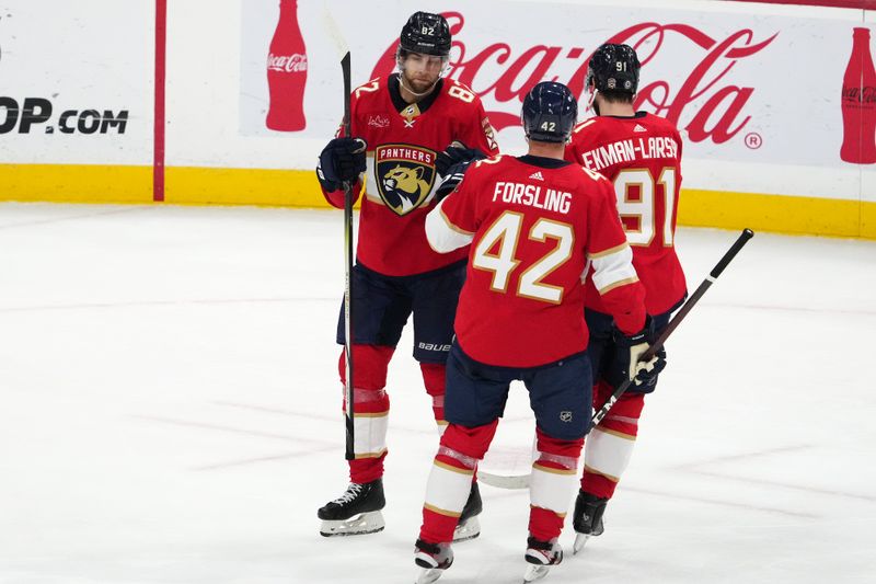 Oct 24, 2023; Sunrise, Florida, USA; Florida Panthers center Kevin Stenlund (82) celebrates his empty net goal against the San Jose Sharks with defenseman Gustav Forsling (42) and defenseman Oliver Ekman-Larsson (91) during the third period at Amerant Bank Arena. Mandatory Credit: Jasen Vinlove-USA TODAY Sports