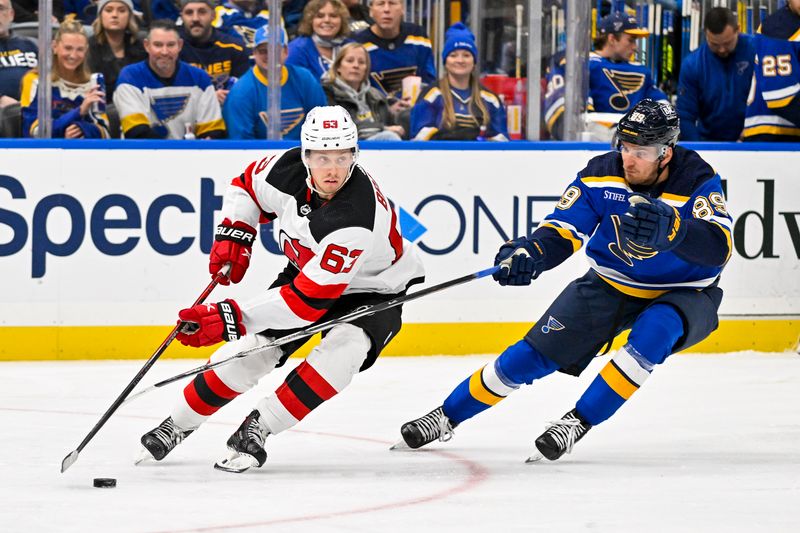 Nov 3, 2023; St. Louis, Missouri, USA;  New Jersey Devils left wing Jesper Bratt (63) controls the puck as St. Louis Blues left wing Pavel Buchnevich (89) defends during the second period at Enterprise Center. Mandatory Credit: Jeff Curry-USA TODAY Sports