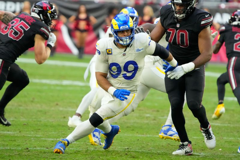 Los Angeles Rams defensive tackle Aaron Donald (99) lines up against the Arizona Cardinals during the first half of an NFL football game, Sunday, Nov. 26, 2023, in Glendale, Ariz. (AP Photo/Rick Scuteri)