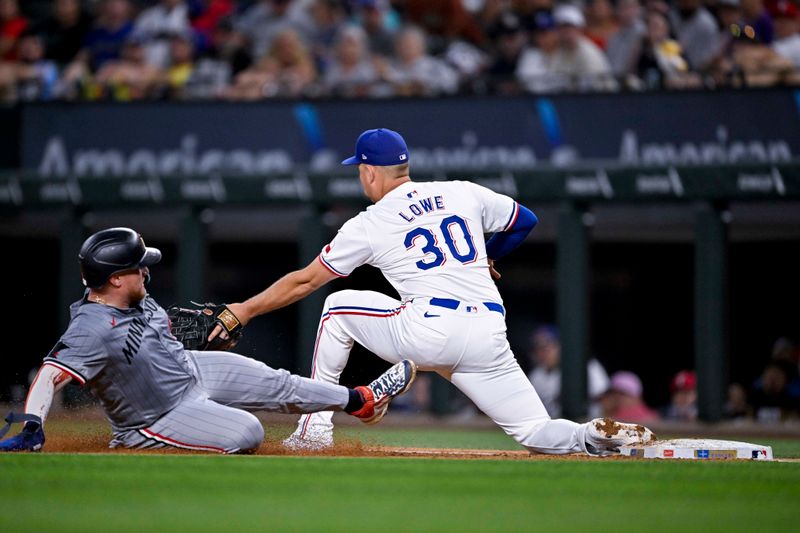 Aug 15, 2024; Arlington, Texas, USA; Texas Rangers first baseman Nathaniel Lowe (30) tags out Minnesota Twins catcher Christian Vazquez (8) during the fourth inning at Globe Life Field. Mandatory Credit: Jerome Miron-USA TODAY Sports