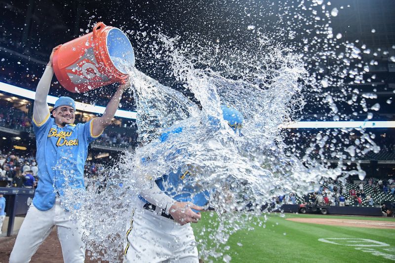 Sep 1, 2023; Milwaukee, Wisconsin, USA; Milwaukee Brewers shortstop Willy Adames, left, dunks third baseman Owen Miller with cold water after the Brewers defeated the Philadelphia Phillies at American Family Field. Mandatory Credit: Benny Sieu-USA TODAY Sports