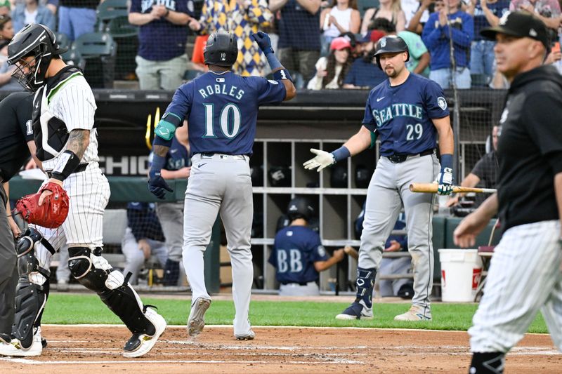 Jul 26, 2024; Chicago, Illinois, USA;  Seattle Mariners outfielder Victor Robles (10) high fives catcher Cal Raleigh (29) after he homers against the Chicago White Sox during the first inning at Guaranteed Rate Field. Mandatory Credit: Matt Marton-USA TODAY Sports