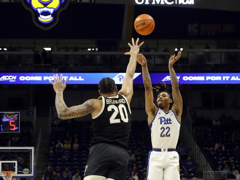 Jan 25, 2023; Pittsburgh, Pennsylvania, USA;  Pittsburgh Panthers guard Nike Sibande (22) shoots a three point basket against Wake Forest Demon Deacons forward Davion Bradford (20) during the second half at the Petersen Events Center. Pittsburgh won 81-79. Mandatory Credit: Charles LeClaire-USA TODAY Sports