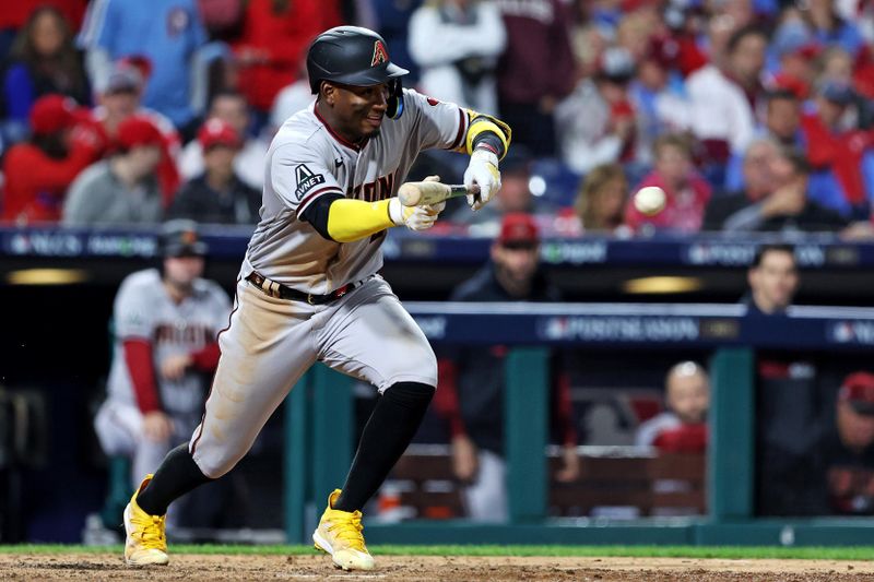 Oct 23, 2023; Philadelphia, Pennsylvania, USA; Arizona Diamondbacks shortstop Geraldo Perdomo (2) bunts for a single during the ninth inning against the Philadelphia Phillies in game six of the NLCS for the 2023 MLB playoffs at Citizens Bank Park. Mandatory Credit: Bill Streicher-USA TODAY Sports