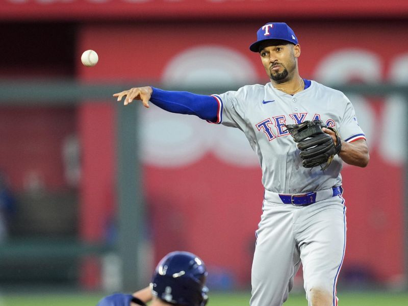 May 3, 2024; Kansas City, Missouri, USA; Texas Rangers second base Marcus Semien (2) throws to first base after forcing out Kansas City Royals designated hitter Vinnie Pasquantino (9) during the sixth inning at Kauffman Stadium. Mandatory Credit: Jay Biggerstaff-USA TODAY Sports