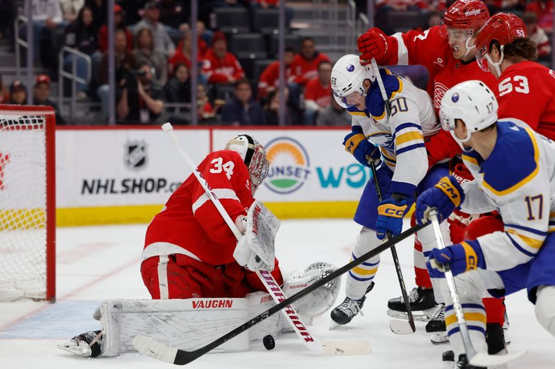 Apr 7, 2024; Detroit, Michigan, USA; Detroit Red Wings goaltender Alex Lyon (34) makes a save on Buffalo Sabres left wing Eric Robinson (50) in the first period at Little Caesars Arena. Mandatory Credit: Rick Osentoski-USA TODAY Sports