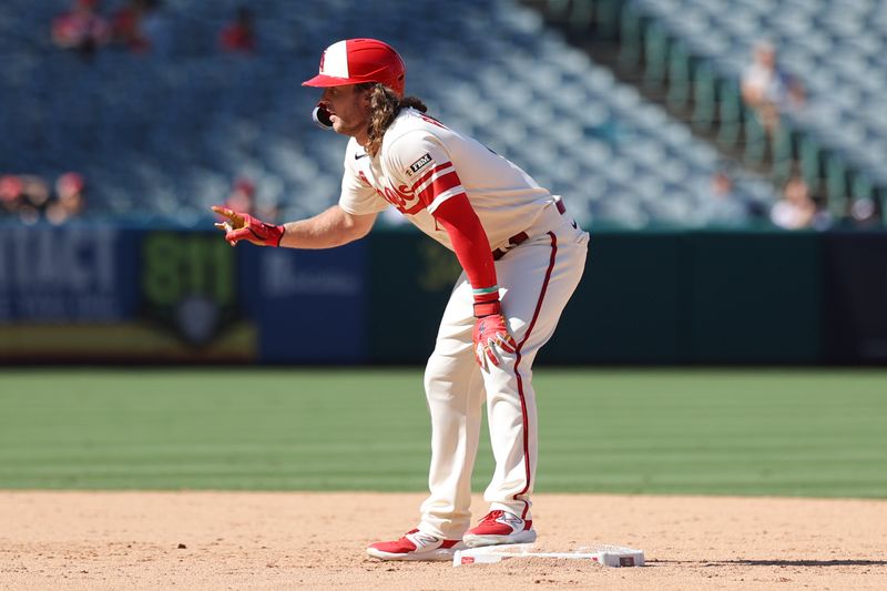 Sep 10, 2023; Anaheim, California, USA; Los Angeles Angels center fielder Brett Phillips (4) gestures reaching second base on a wild pitch against the Cleveland Guardians during the eighth inning at Angel Stadium. Mandatory Credit: Jessica Alcheh-USA TODAY Sports