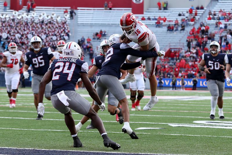 Nov 18, 2023; Tucson, Arizona, USA; Utah Utes quarterback Bryson Barnes (16) is tackled by Arizona Wildcats safety Genesis Smith (12) during the second half at Arizona Stadium. Mandatory Credit: Zachary BonDurant-USA TODAY Sports