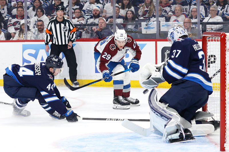 Apr 21, 2024; Winnipeg, Manitoba, CAN;Winnipeg Jets defenseman Josh Morrissey (44) tries to block shot by Colorado Avalanche center Nathan MacKinnon (29) in the first period in game one of the first round of the 2024 Stanley Cup Playoffs at Canada Life Centre. Mandatory Credit: James Carey Lauder-USA TODAY Sports