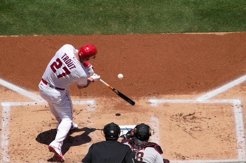 Jul 2, 2023; Anaheim, California, USA; Los Angeles Angels center fielder Mike Trout (27) hits a solo home run in the first inning against the Arizona Diamondbacks at Angel Stadium. Mandatory Credit: Kirby Lee-USA TODAY Sports