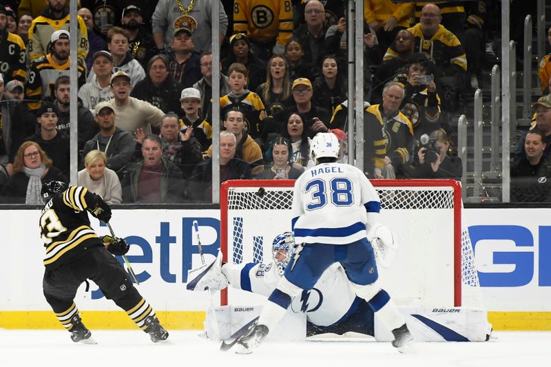 Feb 13, 2024; Boston, Massachusetts, USA;  Boston Bruins left wing Brad Marchand (63) hits the crossbar past the reach of Tampa Bay Lightning goaltender Andrei Vasilevskiy (88) during overtime at TD Garden. Mandatory Credit: Bob DeChiara-USA TODAY Sports