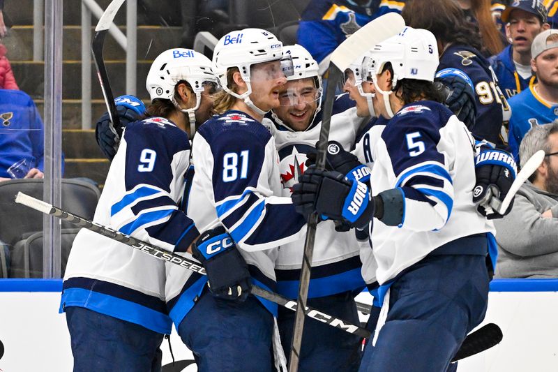 Nov 7, 2023; St. Louis, Missouri, USA;  Winnipeg Jets defenseman Neal Pionk (4) celebrates with teammates after scoring against the St. Louis Blues during the first period at Enterprise Center. Mandatory Credit: Jeff Curry-USA TODAY Sports