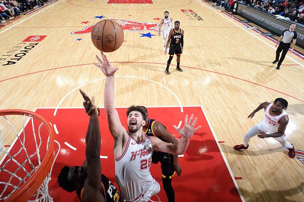 HOUSTON, TX - DECEMBER 27:  Alperen Sengun #28 of the Houston Rockets drives to the basket during the game against the Phoenix Suns on December 27, 2023 at the Toyota Center in Houston, Texas. NOTE TO USER: User expressly acknowledges and agrees that, by downloading and or using this photograph, User is consenting to the terms and conditions of the Getty Images License Agreement. Mandatory Copyright Notice: Copyright 2023 NBAE (Photo by Logan Riely/NBAE via Getty Images)