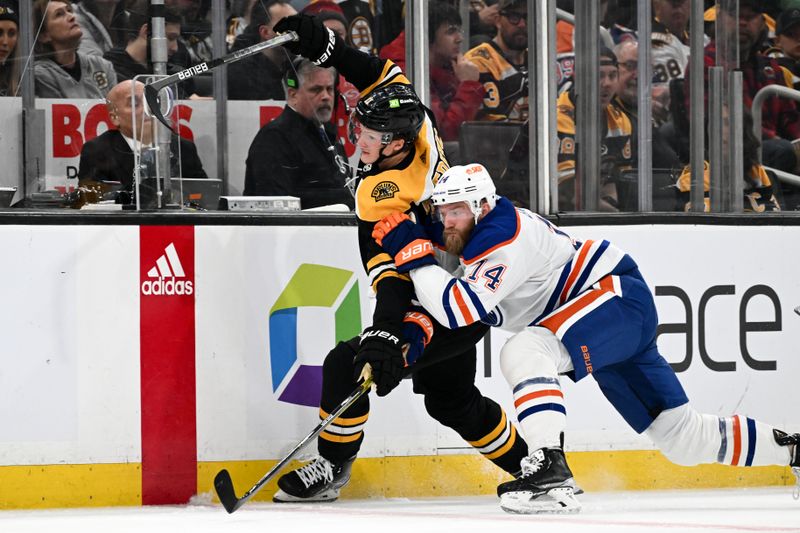 Mar 9, 2023; Boston, Massachusetts, USA; Edmonton Oilers defenseman Mattias Ekholm (14) checks Boston Bruins center Trent Frederic (11) into the boards during the first period at the TD Garden. Mandatory Credit: Brian Fluharty-USA TODAY Sports