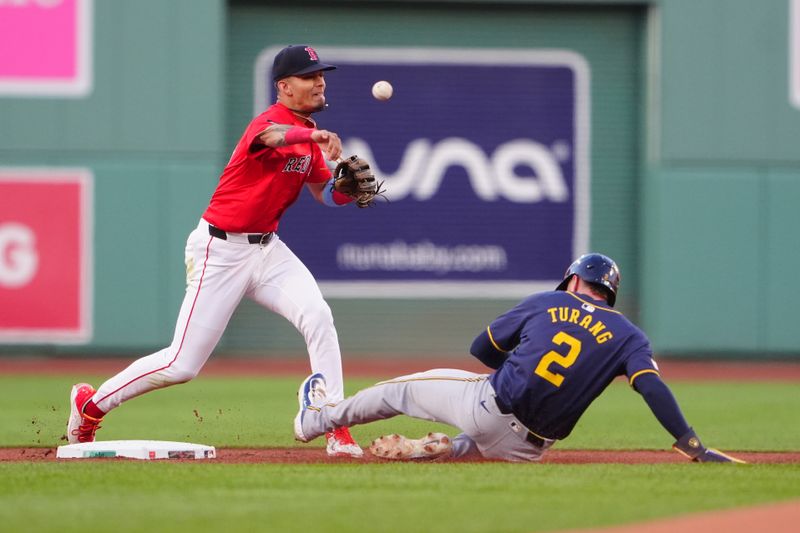 May 24, 2024; Boston, Massachusetts, USA; Boston Red Sox second baseman Vaughn Grissom (5) turns a double play with Milwaukee Brewers second baseman Brice Turang (2) sliding into second base during the first inning at Fenway Park. Mandatory Credit: Gregory Fisher-USA TODAY Sports