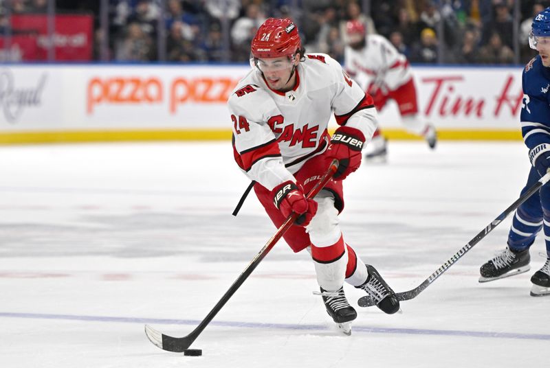 Dec 30, 2023; Toronto, Ontario, CAN; Carolina Hurricanes forward Seth Jarvis (24) carries the puck up ice against the Toronto Maple Leafs in the second period at Scotiabank Arena. Mandatory Credit: Dan Hamilton-USA TODAY Sports