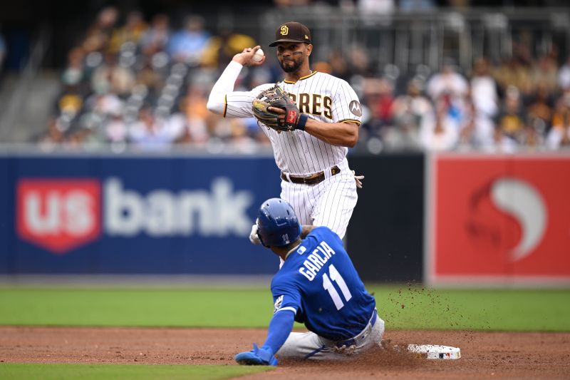 May 17, 2023; San Diego, California, USA; San Diego Padres shortstop Xander Bogaerts (top) throws to first base after forcing out Kansas City Royals third baseman Maikel Garcia (11) at second base to complete a double play during the second inning at Petco Park. Mandatory Credit: Orlando Ramirez-USA TODAY Sports