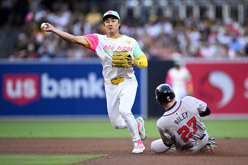 Jul 12, 2024; San Diego, California, USA; San Diego Padres shortstop Ha-Seong Kim (7) throws to first base after forcing out Atlanta Braves third baseman Austin Riley (27) at second base to complete a double play during the fourth inning at Petco Park. Mandatory Credit: Orlando Ramirez-USA TODAY Sports 