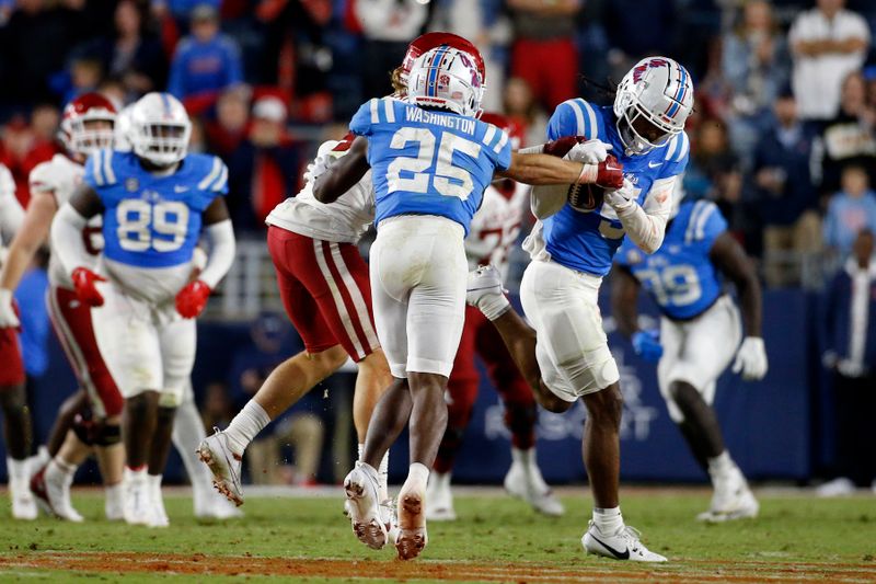 Oct 7, 2023; Oxford, Mississippi, USA; Mississippi Rebels defensive back John Saunders Jr. (5) intercepts the ball during the second half against the Arkansas Razorbacks  at Vaught-Hemingway Stadium. Mandatory Credit: Petre Thomas-USA TODAY Sports