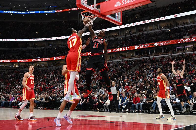 CHICAGO, ILLINOIS - APRIL 04: DeMar DeRozan #11 of the Chicago Bulls dunks the ball against Onyeka Okongwu #17 of the Atlanta Hawks at United Center on April 04, 2023 in Chicago, Illinois. NOTE TO USER: User expressly acknowledges and agrees that, by downloading and or using this photograph, User is consenting to the terms and conditions of the Getty Images License Agreement.  (Photo by Quinn Harris/Getty Images)